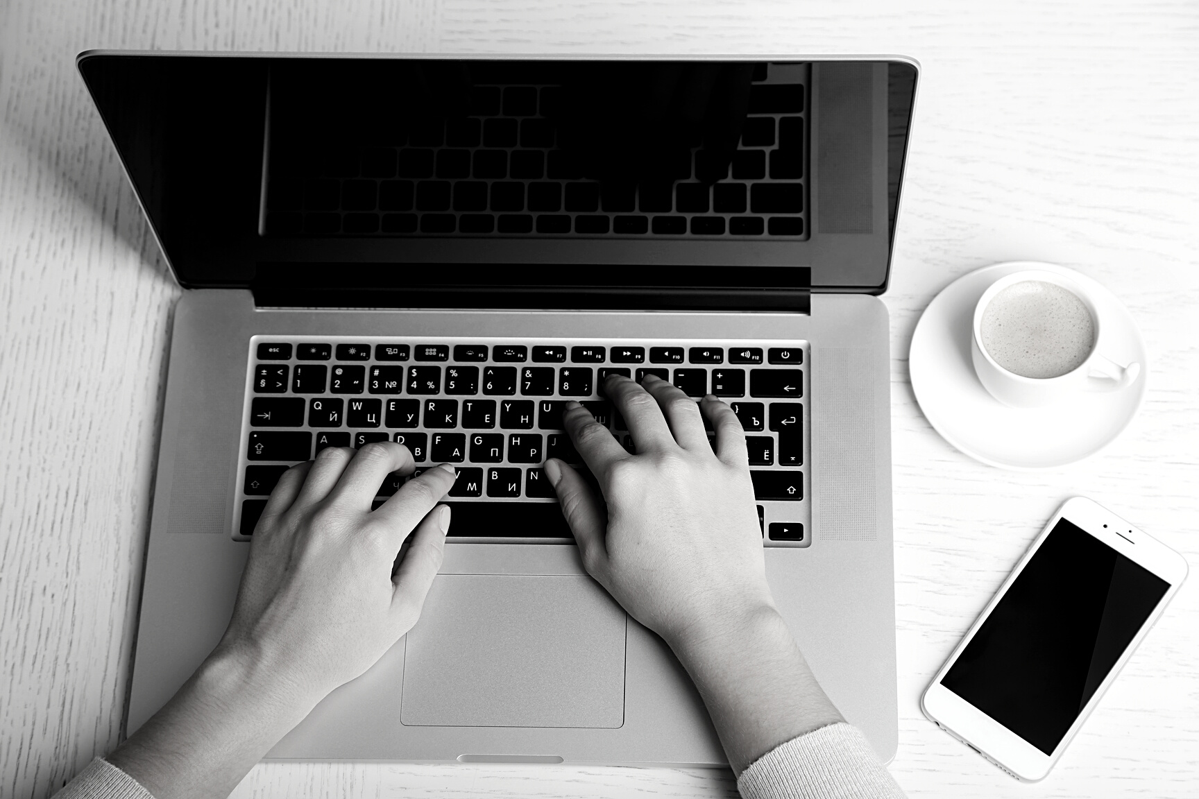 Woman Working with Laptop Placed on Wooden Desk. Top View